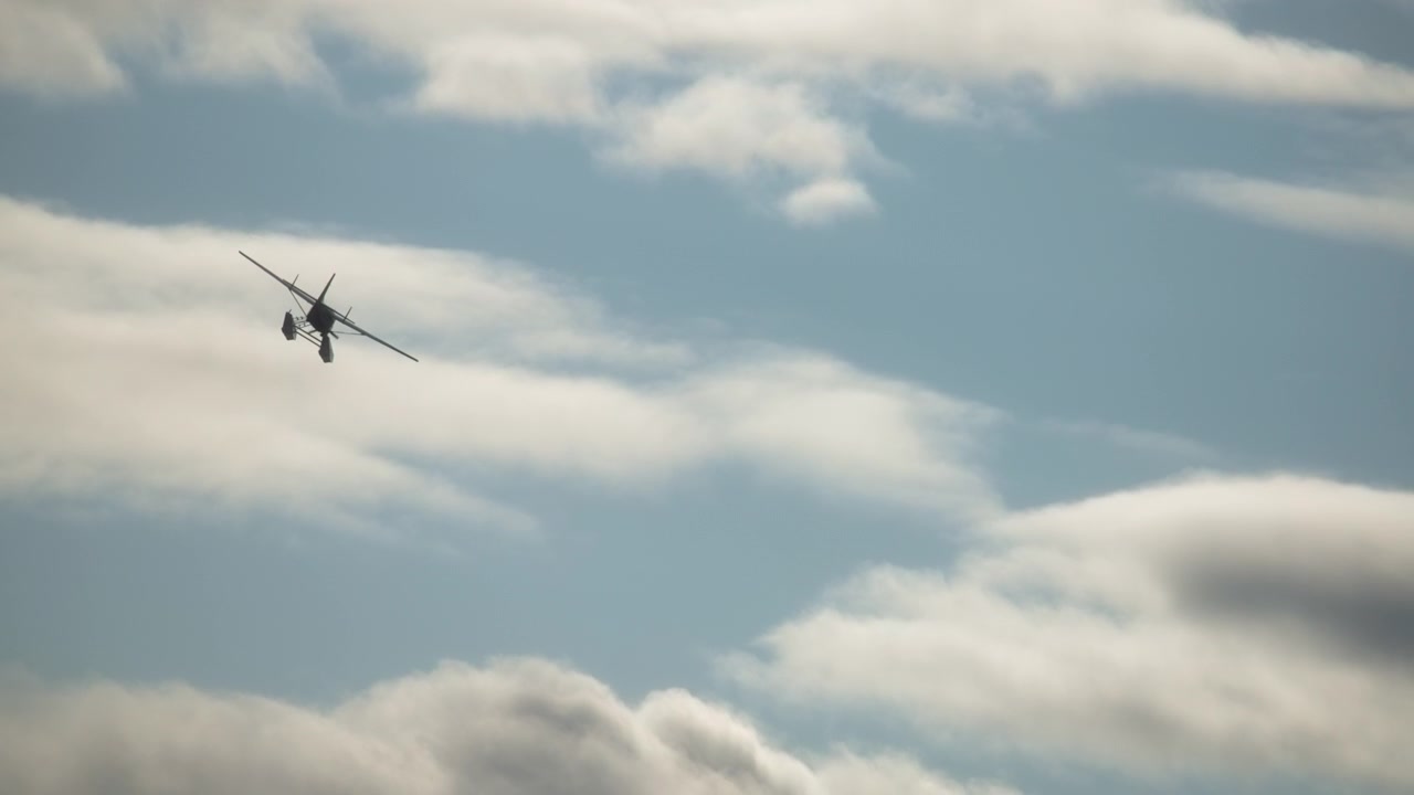 Seaplane flying through the cloudy sky