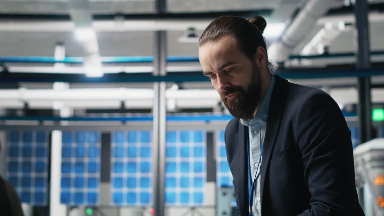 Engineer inspecting solar panel factory