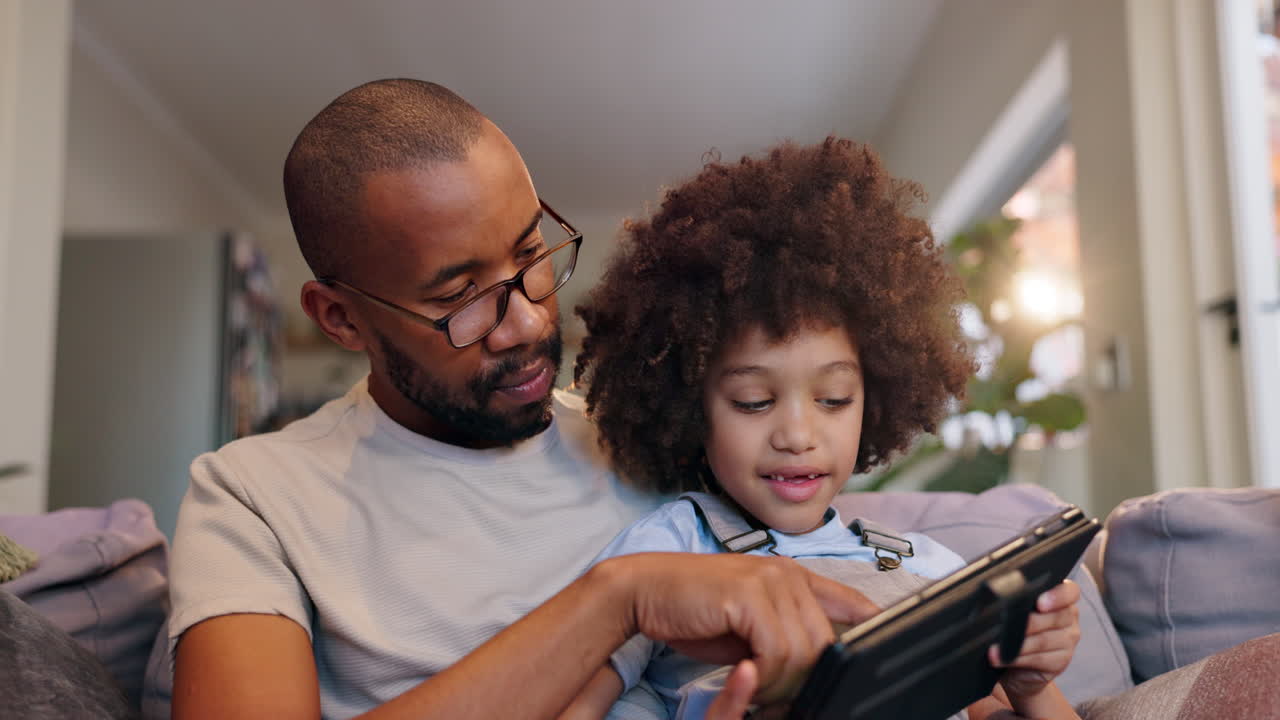 Father and son using a tablet together