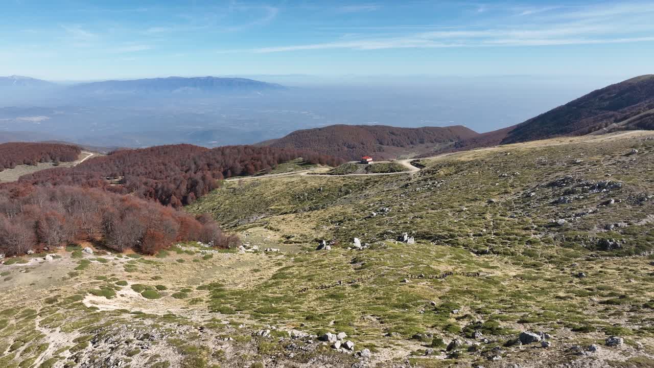 Drone flying across Mount Vermio valley, colorful forest on Greece mountain peak