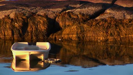 a small boat is at anchor near a lobster village in stonington maine