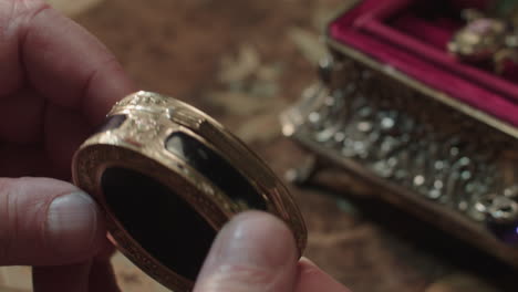an older man evaluates antique box
