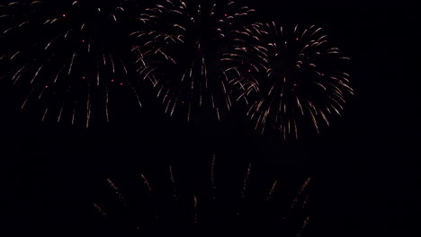 splendid fireworks displays at night sky at celebration event, slow motion