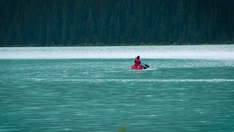 a cute couple canoeing on a peaceful lake