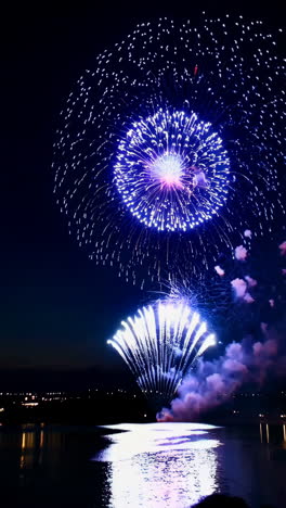 spectacular fireworks display over water at night