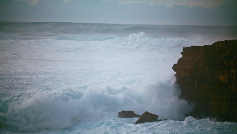 dangerous waves hitting cliff in slow motion. dramatic storm sea breaking rocky