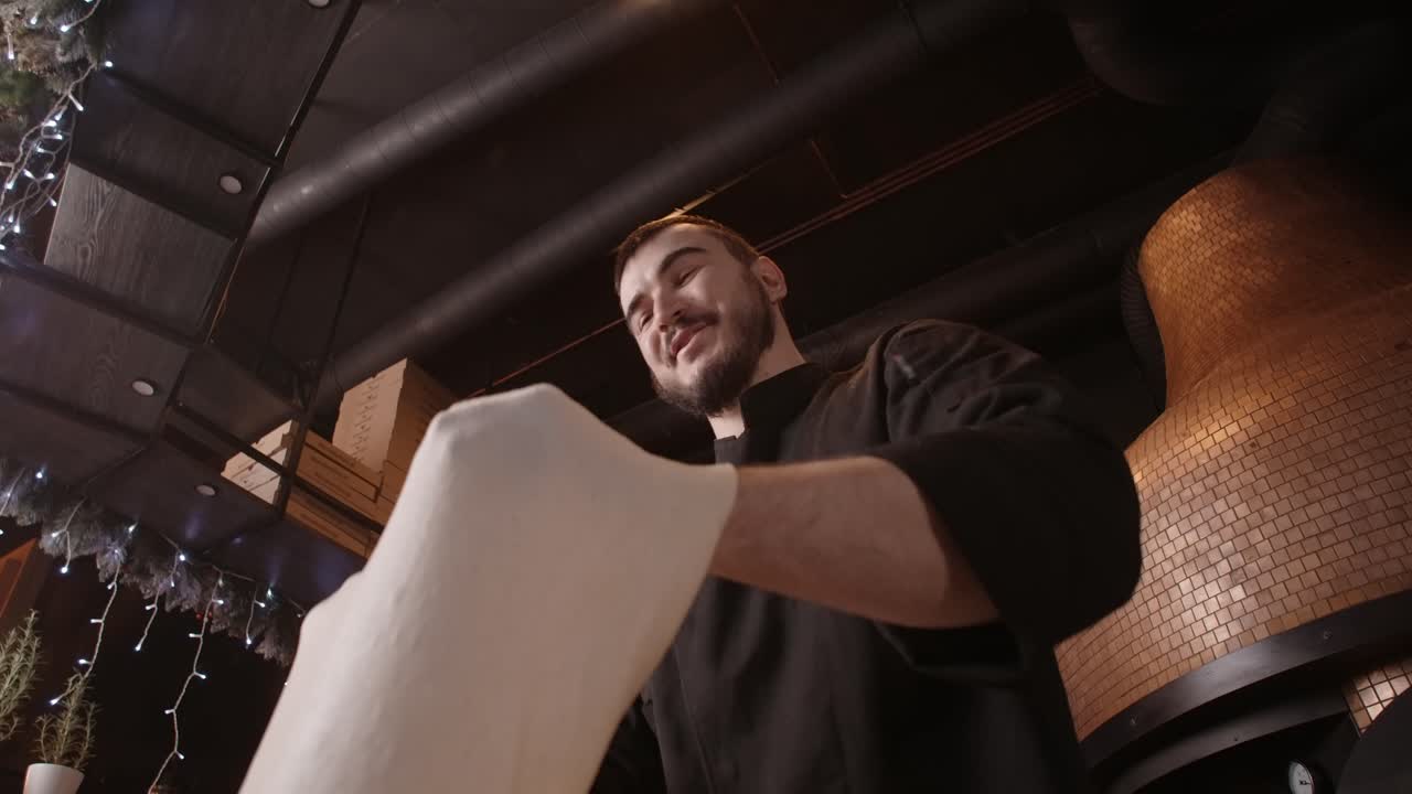 Pizzaiolo preparing pizza dough