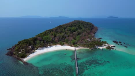 koh kham island with crystal clear turquoise water, white sand beaches and lush tropical vegetation, a popular tourist destination in thailand. great aerial view flight panorama orbit drone
