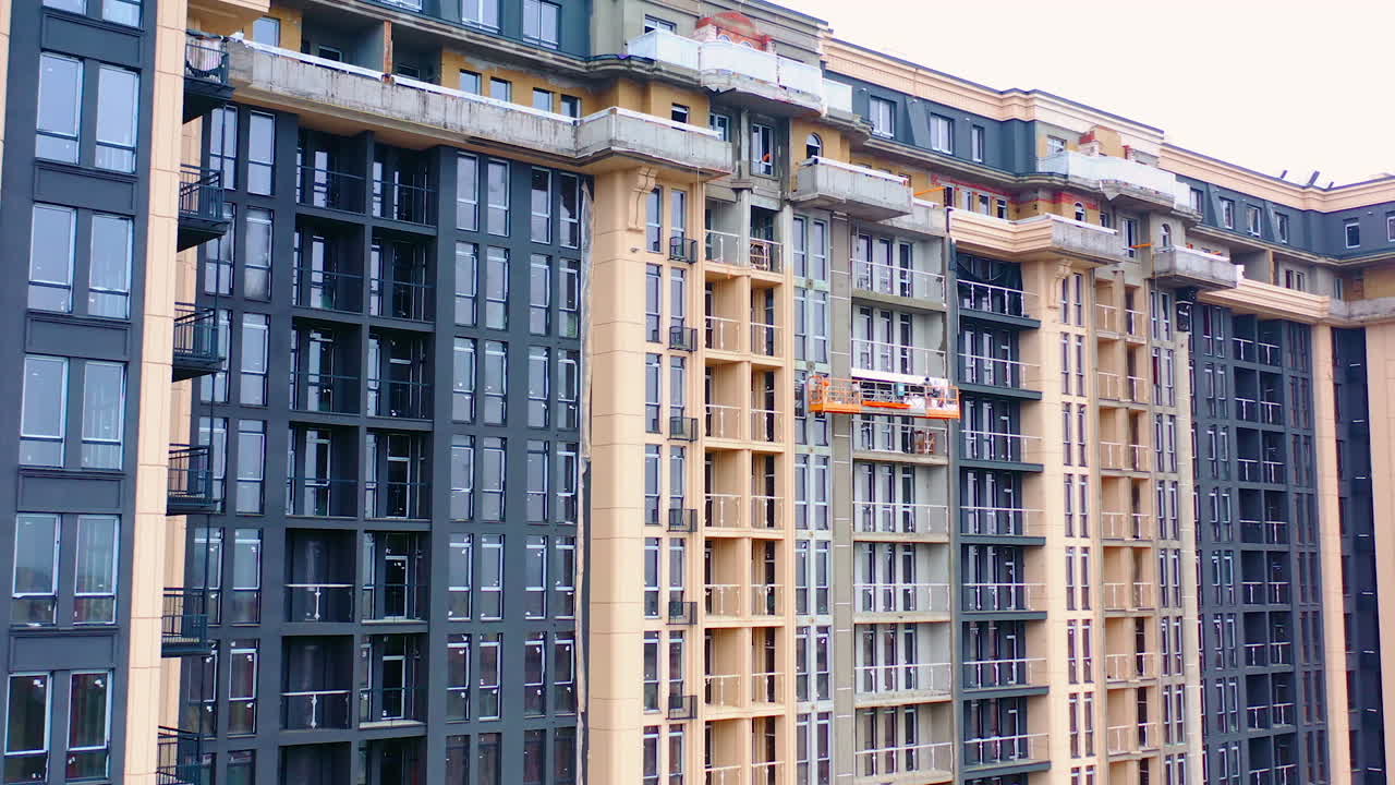 Construction of modern tower building. Exterior of a new architecture in the city. Building of high-rise house.