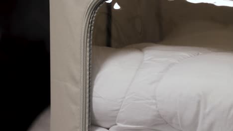 ropa de cama ordenada en una caja de organizador cerrada