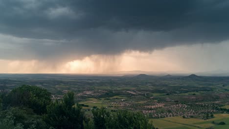 dramatic view of la alcarria plains from a viewpoint during a powerful storm, with rain curtains and dark clouds sweeping across the landscape