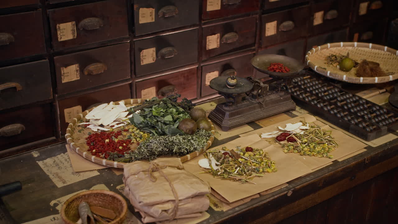 Table with Traditional Dried Asian Herbs and Scales on Table at Drug Store