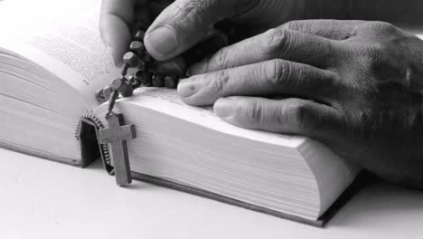 praying-to-God-with-hand-on-bible-with-white-background-with-people-stock-footage