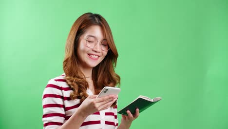 Asian-young-woman-book-ticket-with-her-passport-in-hands-in-studio-with-chroma-key-background