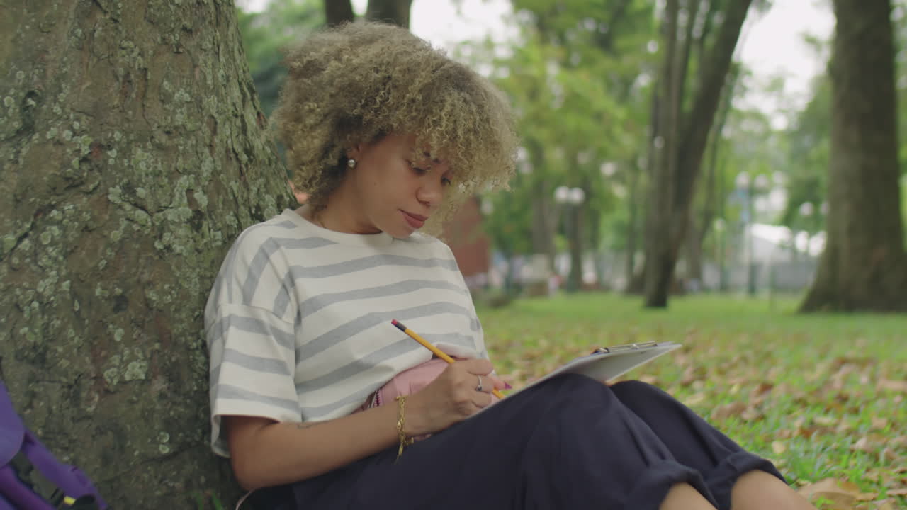 Latin Female Student Doing Homework in Park