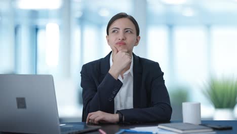 confused indian female manager thinking about something