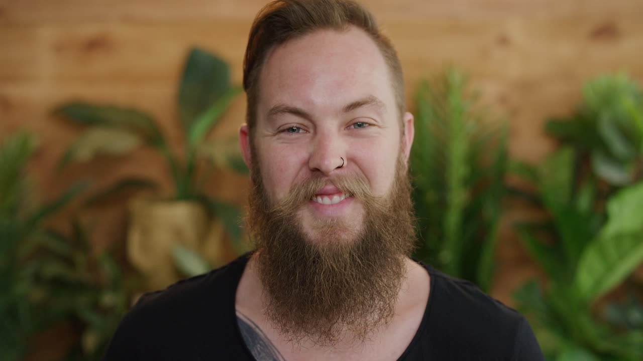 retrato de un joven hipster sonriente feliz disfrutando del éxito del estilo de vida hombre caucásico con barba que parece alegre serie de personas reales