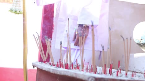 person performing a traditional incense offering