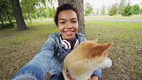 girl and dog selfie in a park