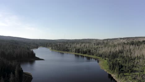 Fly-over-a-scenic-lake-in-the-harz-national-park,-Germany