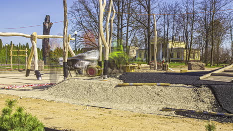 laying the rubber turf mulch at a newly built playground in a public park for child safety - time lapse