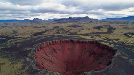 aerial view of a striking volcanic crater in a desolate landscape