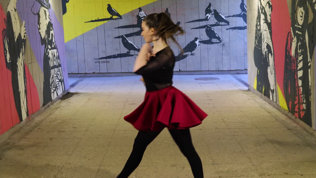 Breath taking beautiful dancer dances and spins while leaving the underground passage