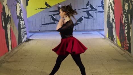 breath taking beautiful dancer dances and spins while leaving the underground passage