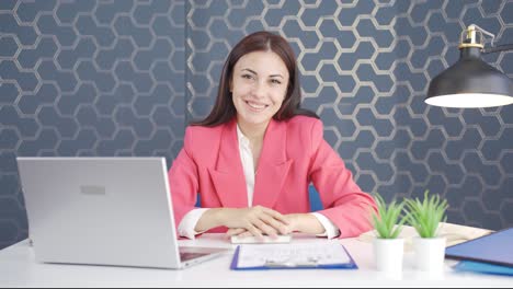 Young-business-woman-winking-at-camera.