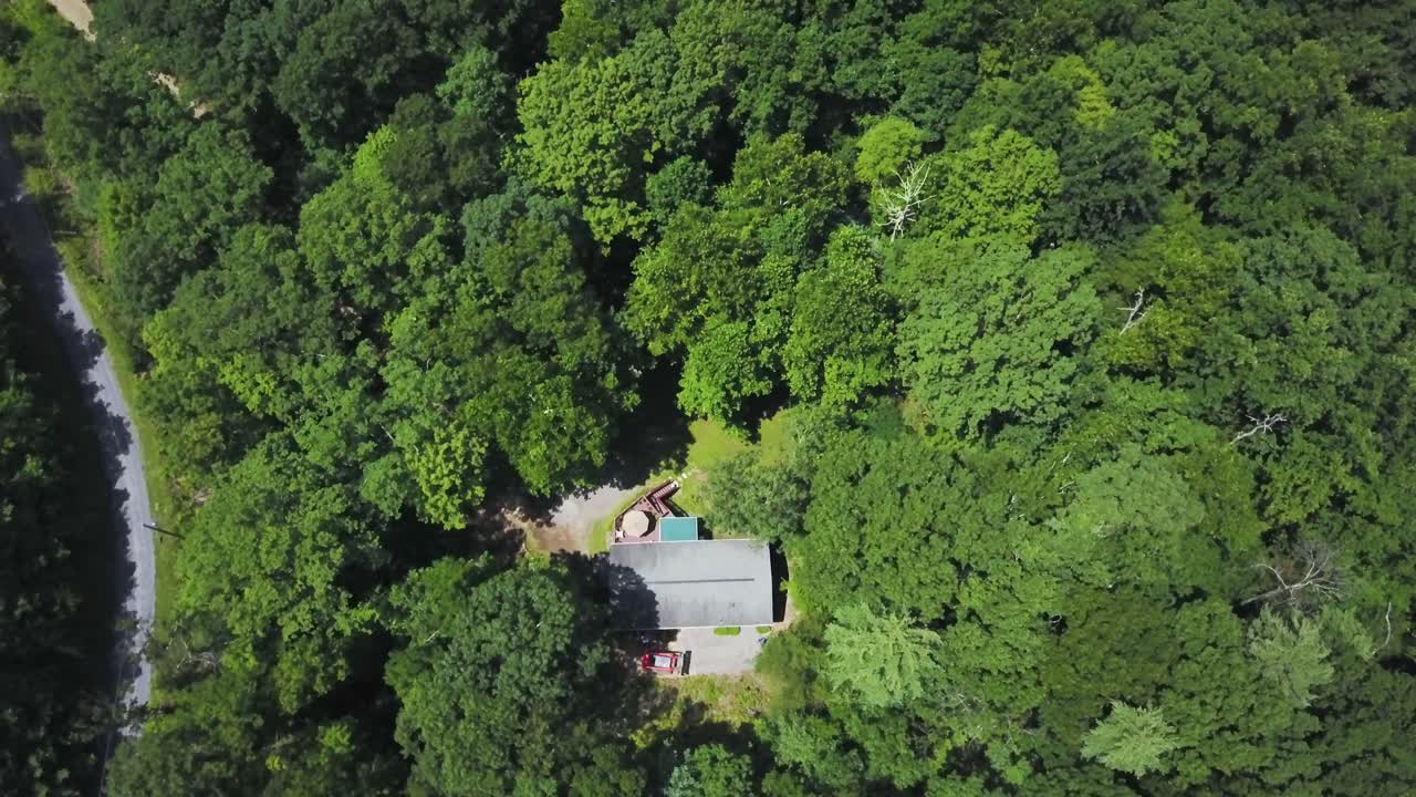 Aerial View of a House Surrounded by Forest