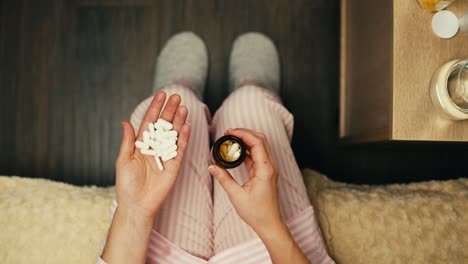 woman taking medication in bed