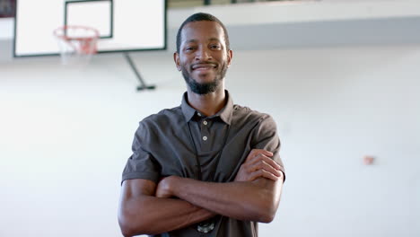 Confident-African-American-coach-stands-in-a-gym