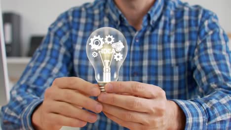 man in a plaid shirt holding a lightbulb with a creative idea concept