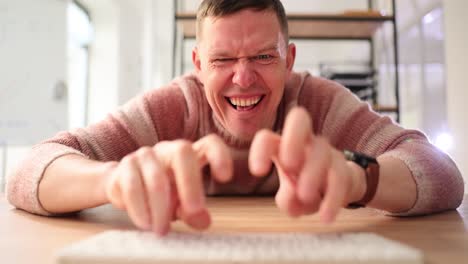 man typing on a keyboard at a desk