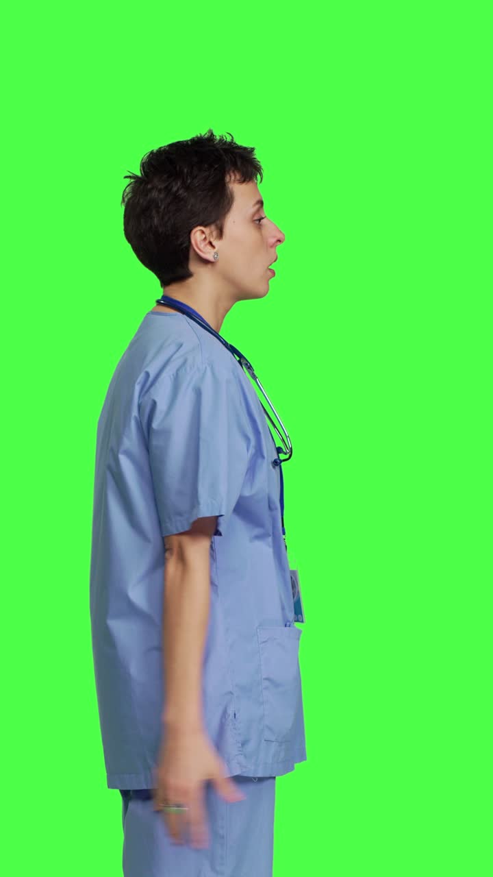 Profile Stressed furious nurse screaming at someone against greenscreen backdrop