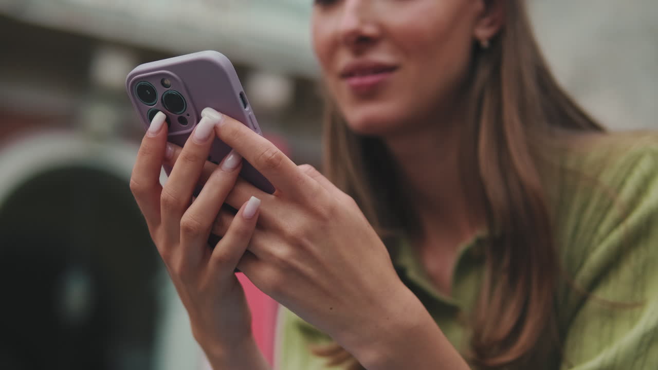 Close-up of Young Woman's Hands Using a Smartphone
