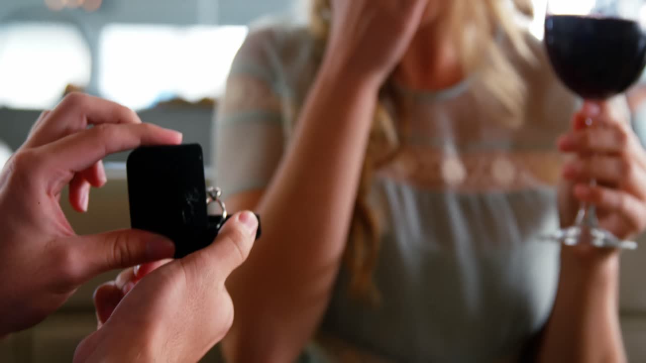Man surprising woman with a engagement ring