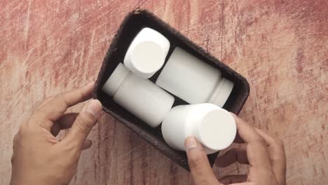 hands holding a basket with white containers