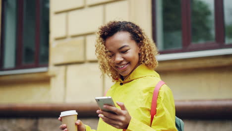 young woman using a phone in the rain