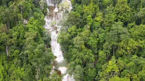 Aerial-Overhead-View-Of-Kuang-Si-Falls-Cascading-Down-Surrounding-By-Tropical-Forest-Trees-In-Luang-Prabang