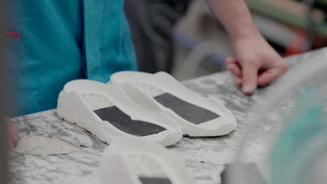 white shoe soles in production at a shoe factory, ready for assembly