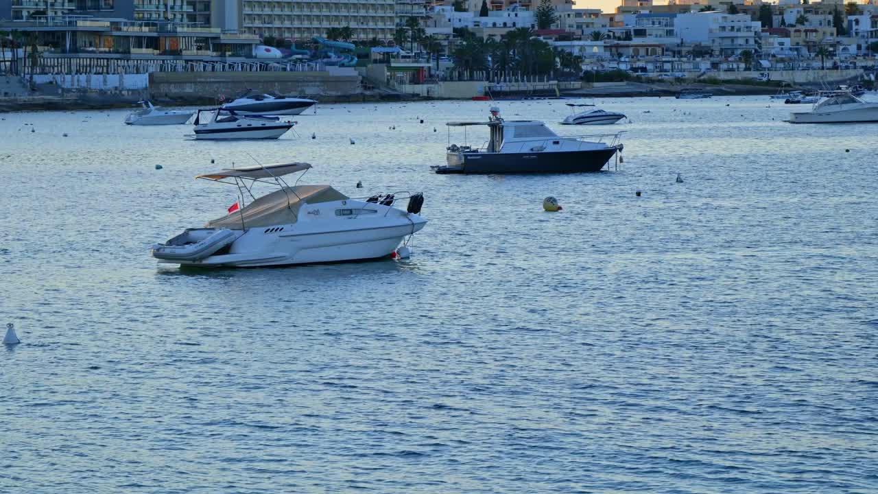 Serene evening at a marina with pleasure boats gently moored, reflecting soft twilight colors on calm water.