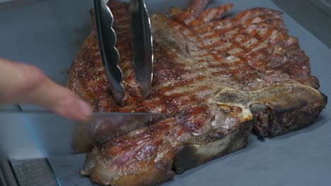 close-up of slicing a barbecued pork chop steak