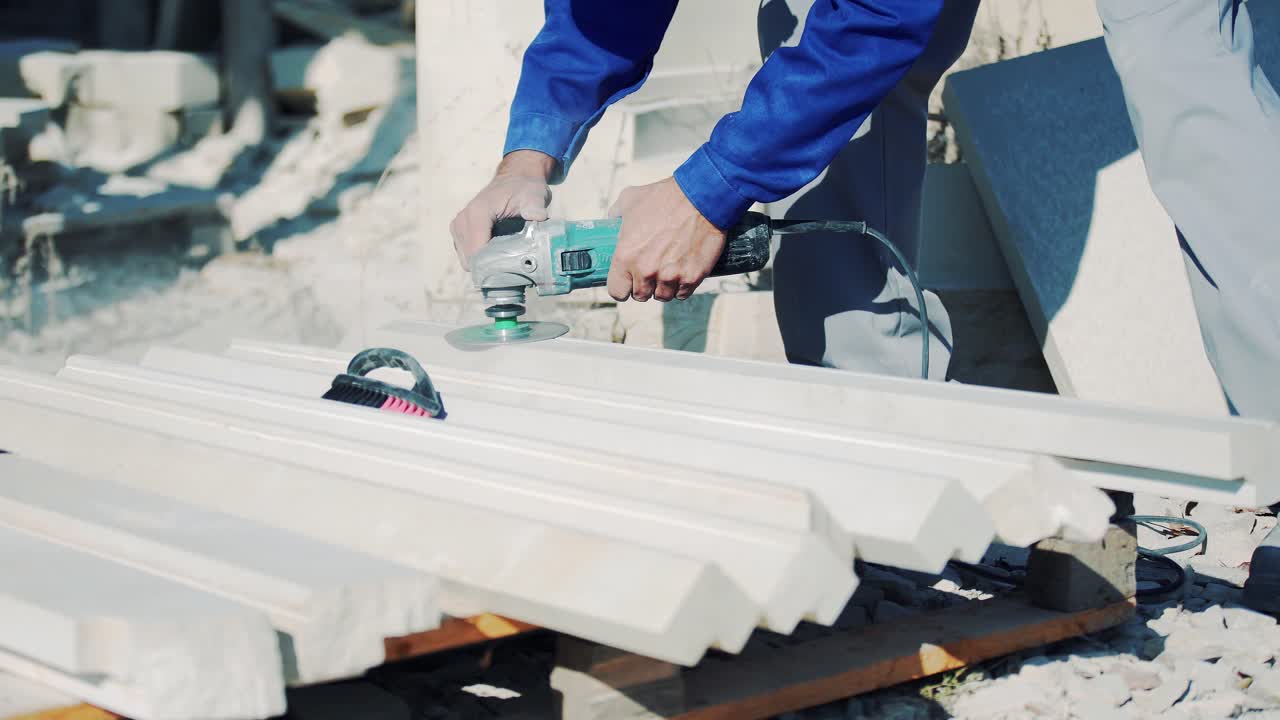Polishing a stone with an electric angle grinder. Sandstone art processing factory