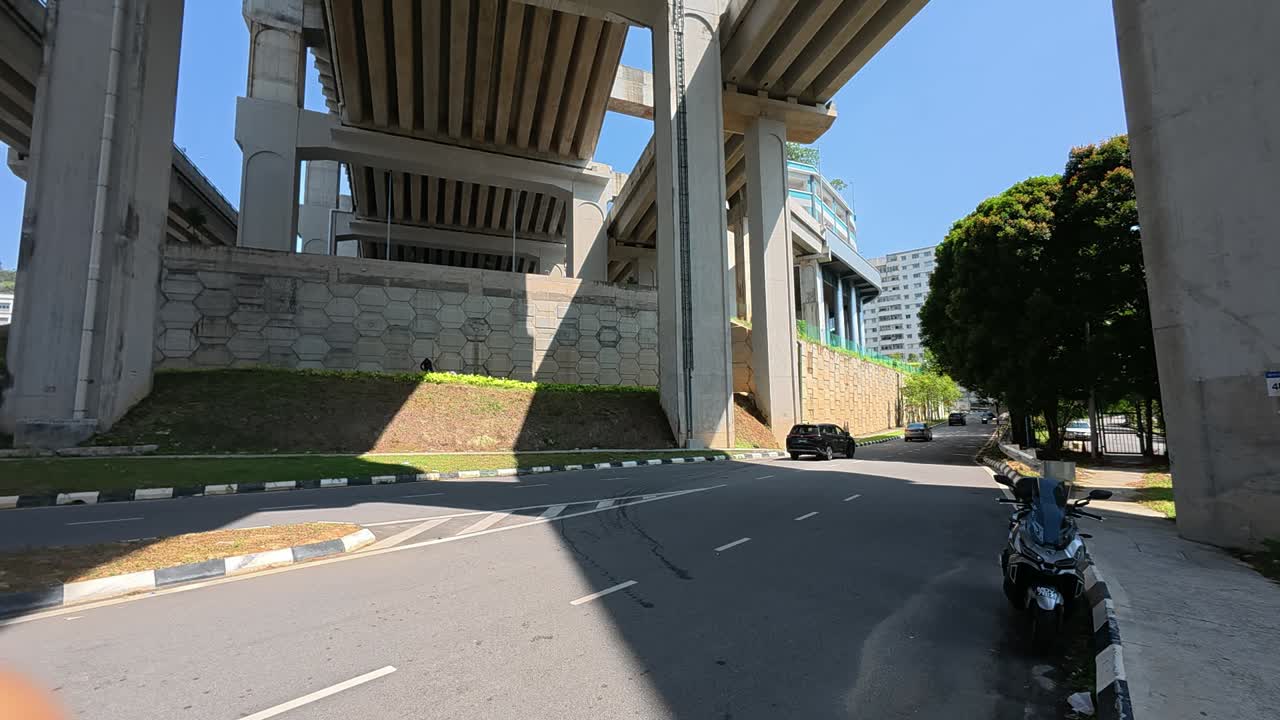 A low-angle view of a high elevated road shows massive concrete pillars, beams, and portals. This engineering marvel is designed to disperse heavy ground traffic