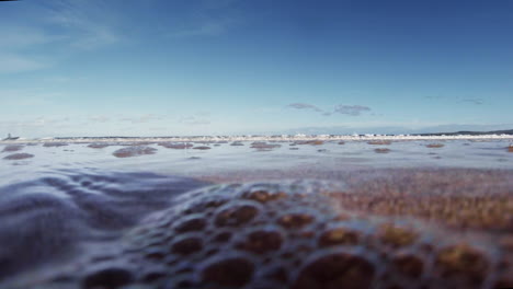 the tide rolls in and envelops the camera