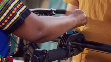 people clamping bicycle to repair stand