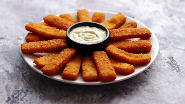 Crumbed fish sticks served with garlic dip sauce