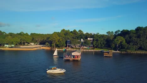 a fun family feeling is portrayed during a crab boil out on a dock over the water