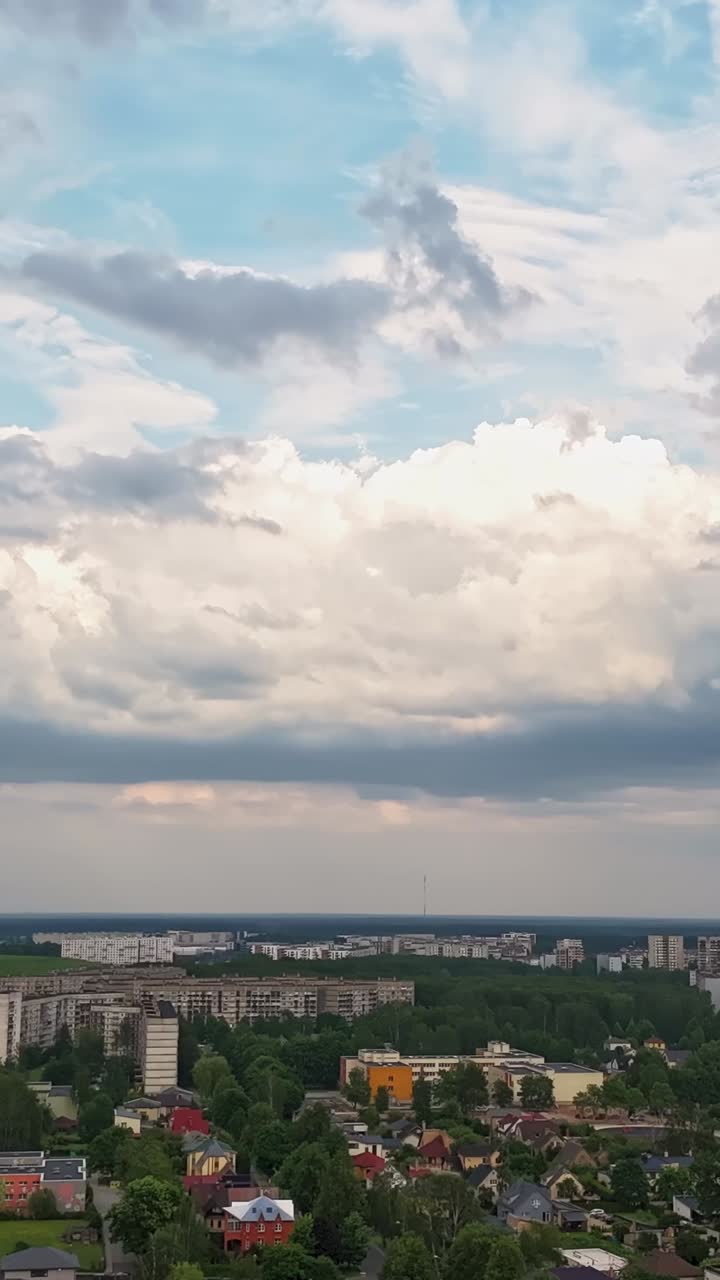 Vertical aerial time-lapse of Riga’s Darzciems district with clouds drifting above